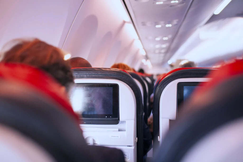 Passengers seated in an aircraft cabin on a transatlantic business flight from Ireland